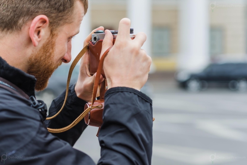 side-view-man-focusing-with-camera